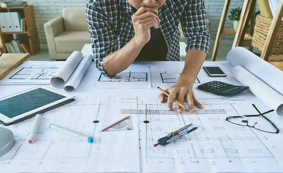 Engineer reviewing system drawings and plans